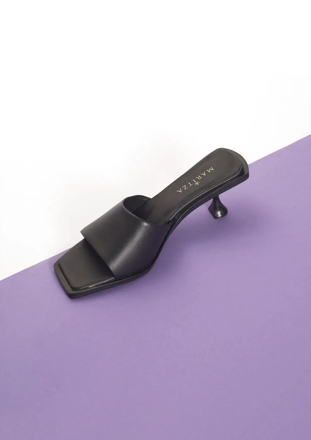 MARITZA black leather mule with a wide square-toe band on a sculpted spool kitten heel
