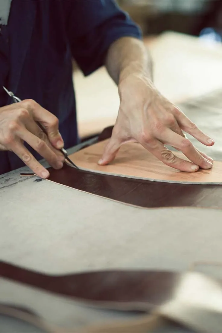 Skilled hands cutting genuine leather at MARITZA's Derimer tannery